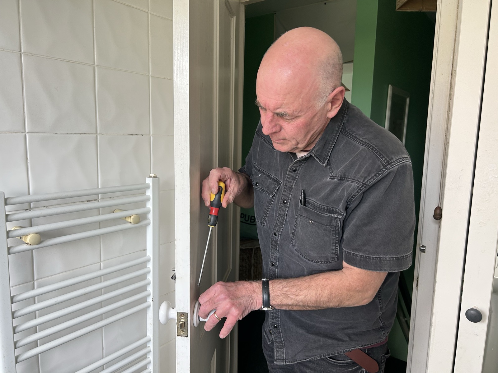 Oz the Carpenter adjusting a door lock